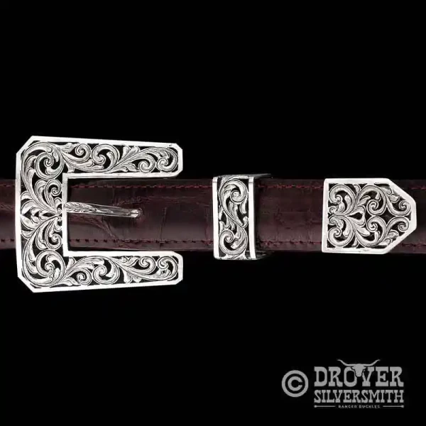 The Cattleman Sterling Silver Belt Buckle features an astonishing filigree style with free space between silver scrolls in the buckle, tool and tip. Upgrade for larger size available!